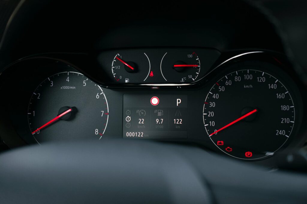Vue détaillée d'un tableau de bord de voiture moderne avec compteur de vitesse et indicateurs de jauge de carburant.